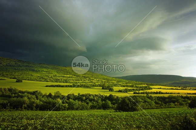 Green hills in mountain valley stormy landscape photo white weather view vibrant valley travel sunrise sunny sunlight sun summer spring sky season scenery scene rural plant Plain pasture paradise outdoor nature natural mountain meadow light lawn landscape land horizon hill grow green grassland grass fresh flower field farm environment day countryside country colorful color cloudy cloudscape cloud clear bright blue beauty beautiful background alpine agriculture 54ka StockPhoto