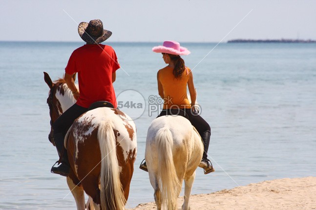 Horse Riding on the Beach young Vacations Two People Two Animals travel sport sky sea saddle Riding Purebred Horse outdoors Men Individual Sports horseback horse holiday Harness Girls cool Coastline riding Coastline blue Beauty In Nature beauty beautiful beach animals animal Activity 54ka StockPhoto