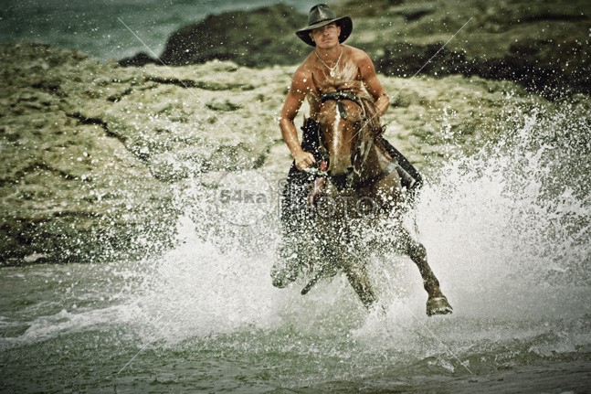 Man riding fast horse in the seawater young wild wet water trail tourism thoroughbred summer Standing stallion spring splashing speed sea satisfied saddle Running river rider ride Quick power pond outside outdoor ocean nature moving Motion mare man mammal landscape Lake journey horseman horseback horse gallop front freedom free equine equestrian domestic cowboy country brown beauty beautiful beach bathing animal action 54ka StockPhoto